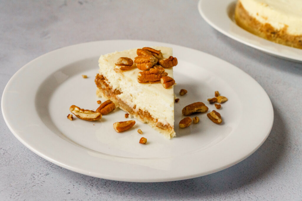 Delicious Cheesecake with Pecans on White Plate – Dessert Wallpaper