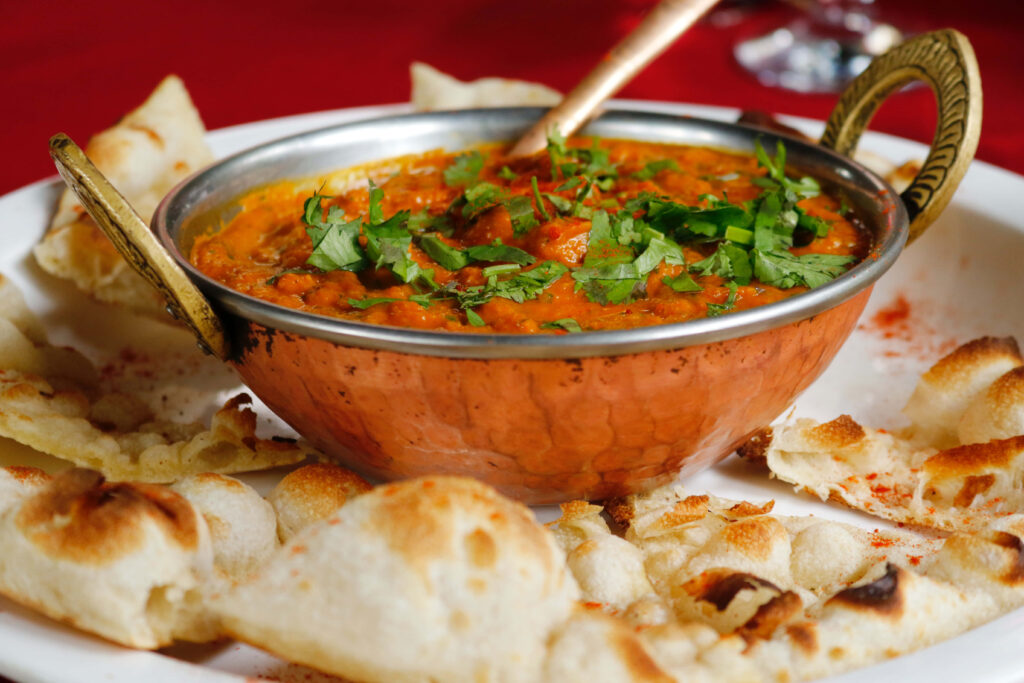 Savory Chicken Tikka Masala Wallpaper with Naan - Indian Cuisine Art