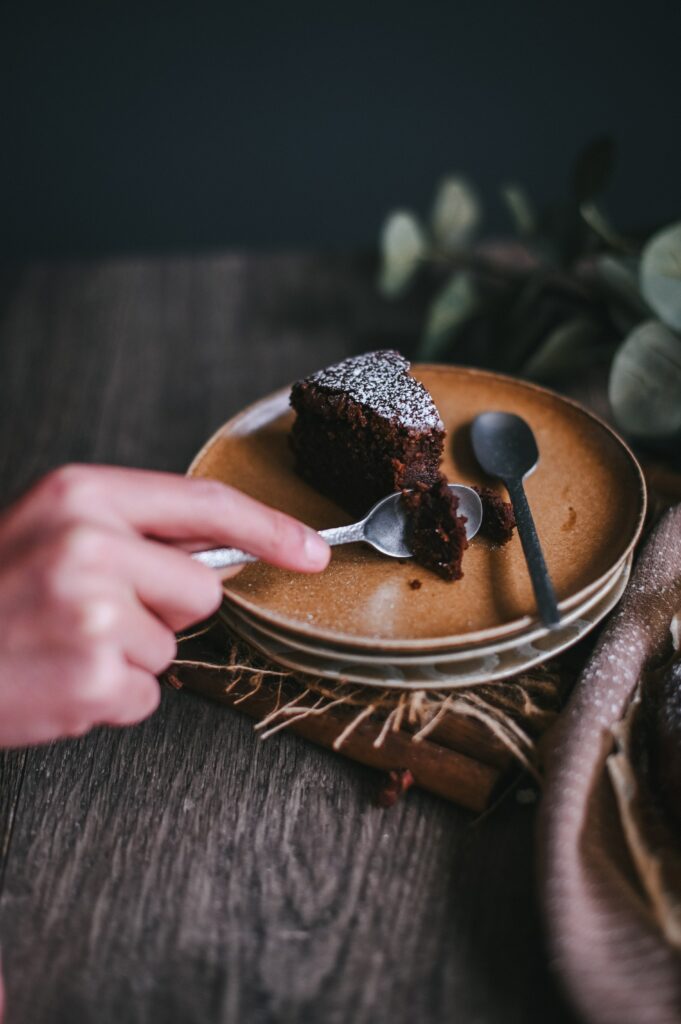 Indulgent Chocolate Cake Slice with Two Spoons - Dessert Wallpaper