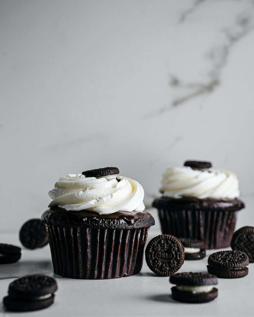 Delectable Chocolate Cupcake Wallpaper with Creamy Frosting & Cookies