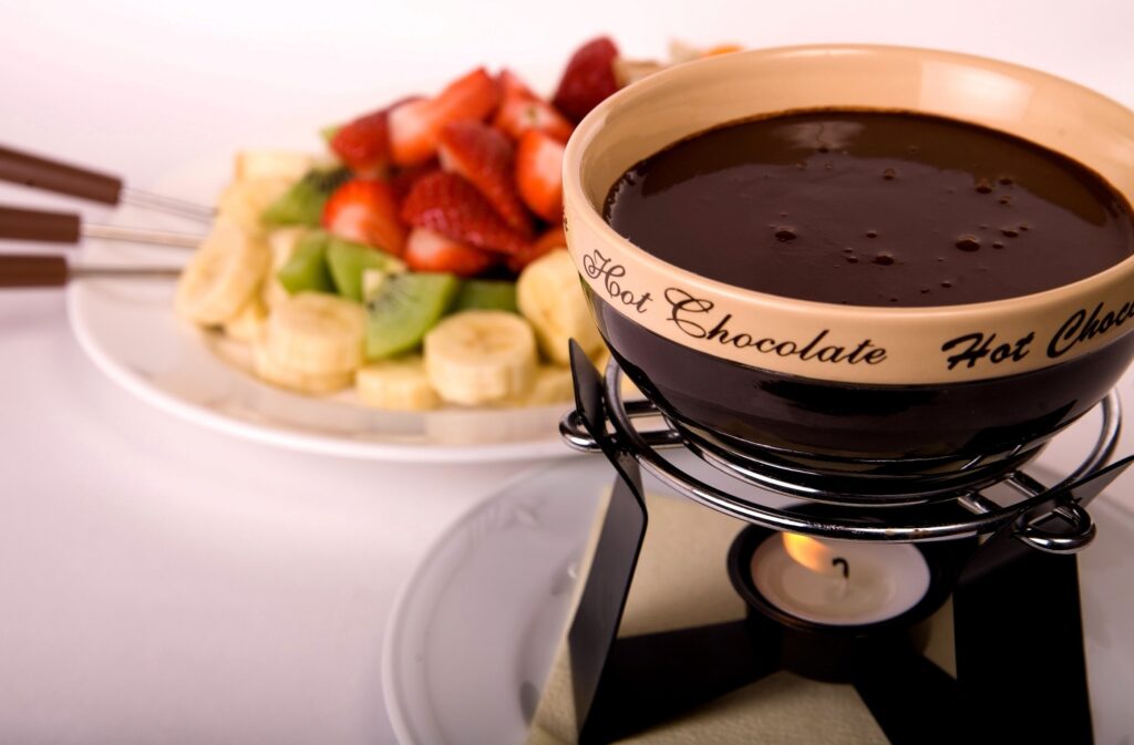 Delicious Chocolate Fondue with Fresh Fruits - Warm Candlelit Setup Wallpaper