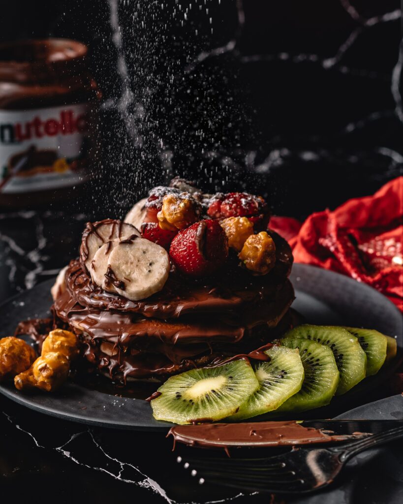 Delicious Chocolate Pancake Stack with Fresh Fruits & Nutella Wallpaper