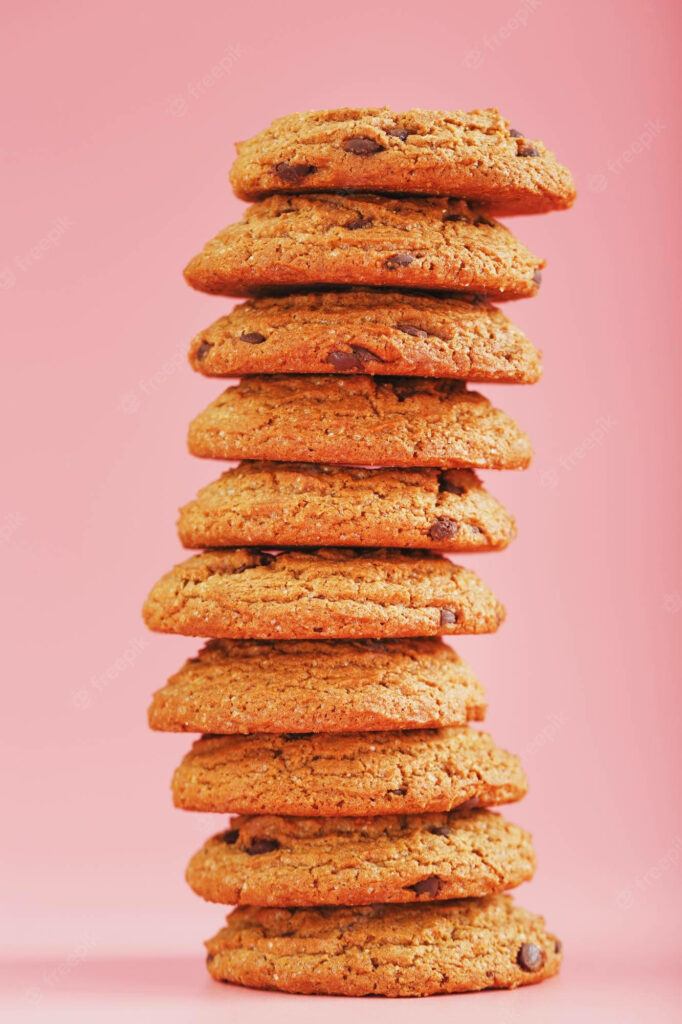 Satisfy Your Sweet Tooth: Irresistible Oatmeal Cookie Tower on a Vibrant Pink iPhone Background Wallpaper