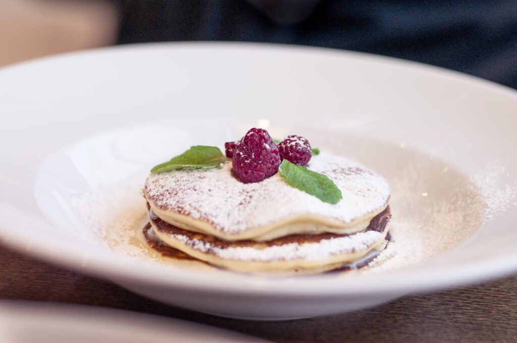 Elegant Pancake Wallpaper: Fluffy Stack with Raspberries & Mint