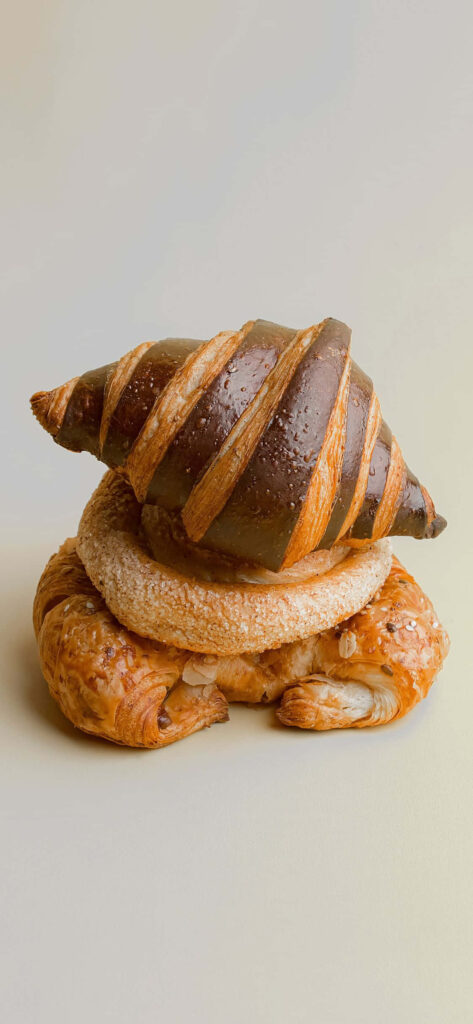 Elegant Chocolate Croissant Stack on Sugar-Dusted Pastries Wallpaper