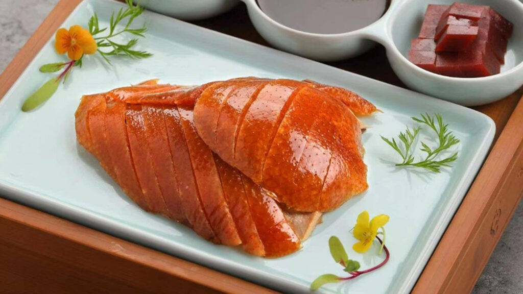 Succulent Roasted Peking Duck Wallpaper with Vibrant Garnishes