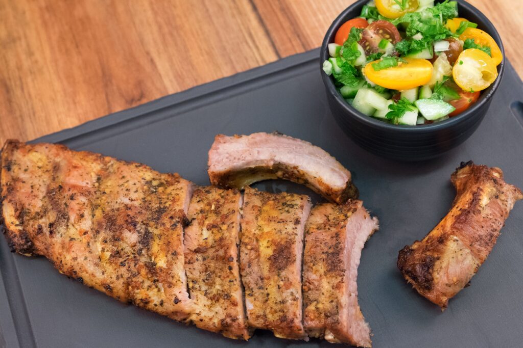 Delectable Roasted Pork Ribs & Fresh Vegetables Wallpaper Background