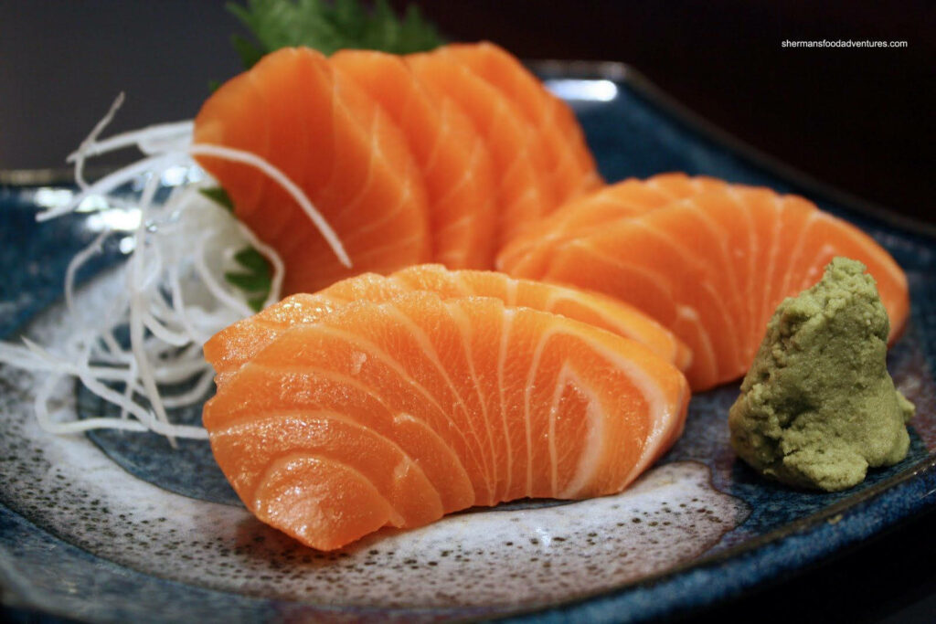 Fresh Salmon Sashimi Wallpaper with Wasabi & Radish Garnish