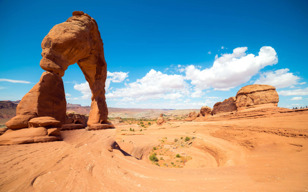 Delicate Arch Utah orange sandstone with swirling rock formations under vivid blue sky wallpaper