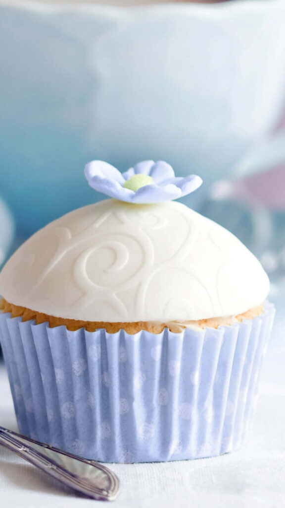 Dreamy Delights: A Sweet Cupcake Amidst Desserts Wallpaper