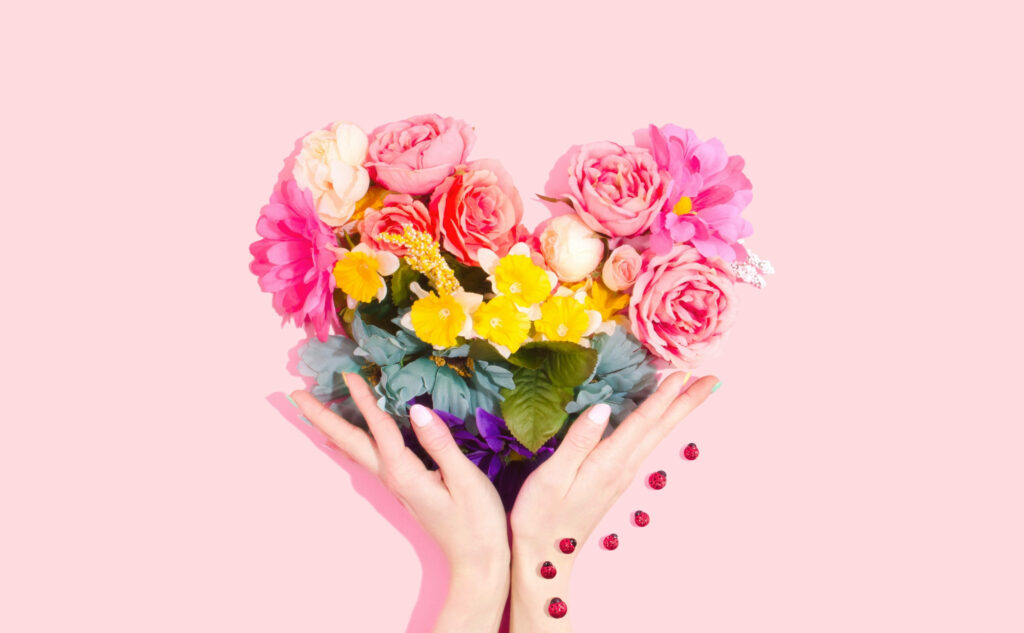 Heart-Shaped Flower Bouquet Wallpaper on Soft Pink Background