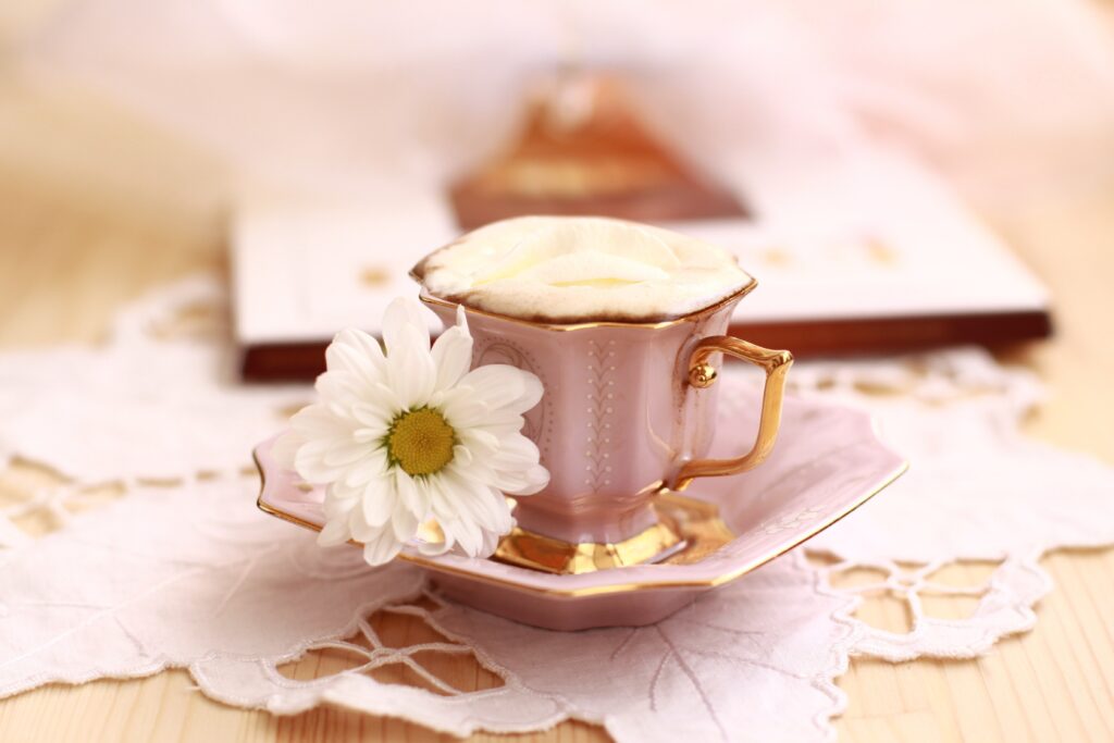 Pastel Pink Coffee Cup Still Life Wallpaper with Daisy and Lace