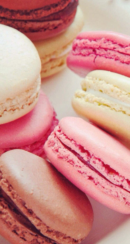 Sweet Delights: Irresistible Macarons against Desserts Backdrop Wallpaper