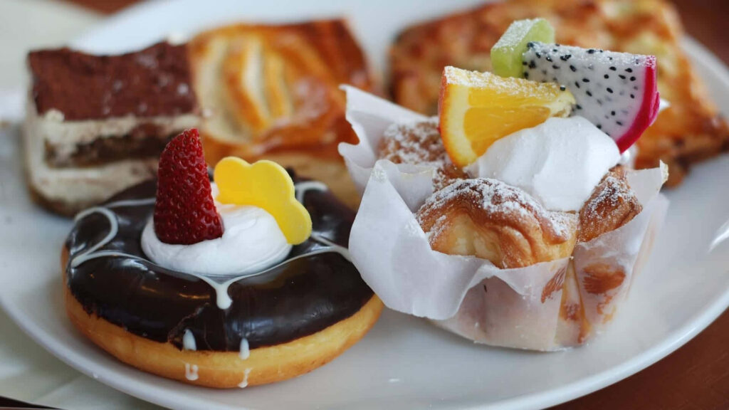 Assortment of Pastries Presented on a Scrumptious Desserts Background Wallpaper