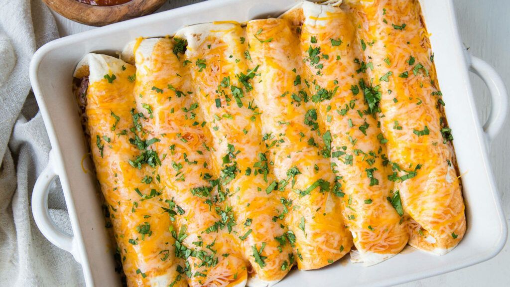 Delicious Baked Enchiladas with Cheese & Herbs on White Tray Wallpaper