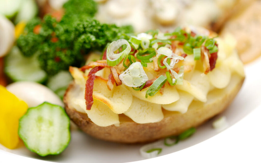 Delicious Baked Potato Dish with Green Onions & Bacon Wallpaper