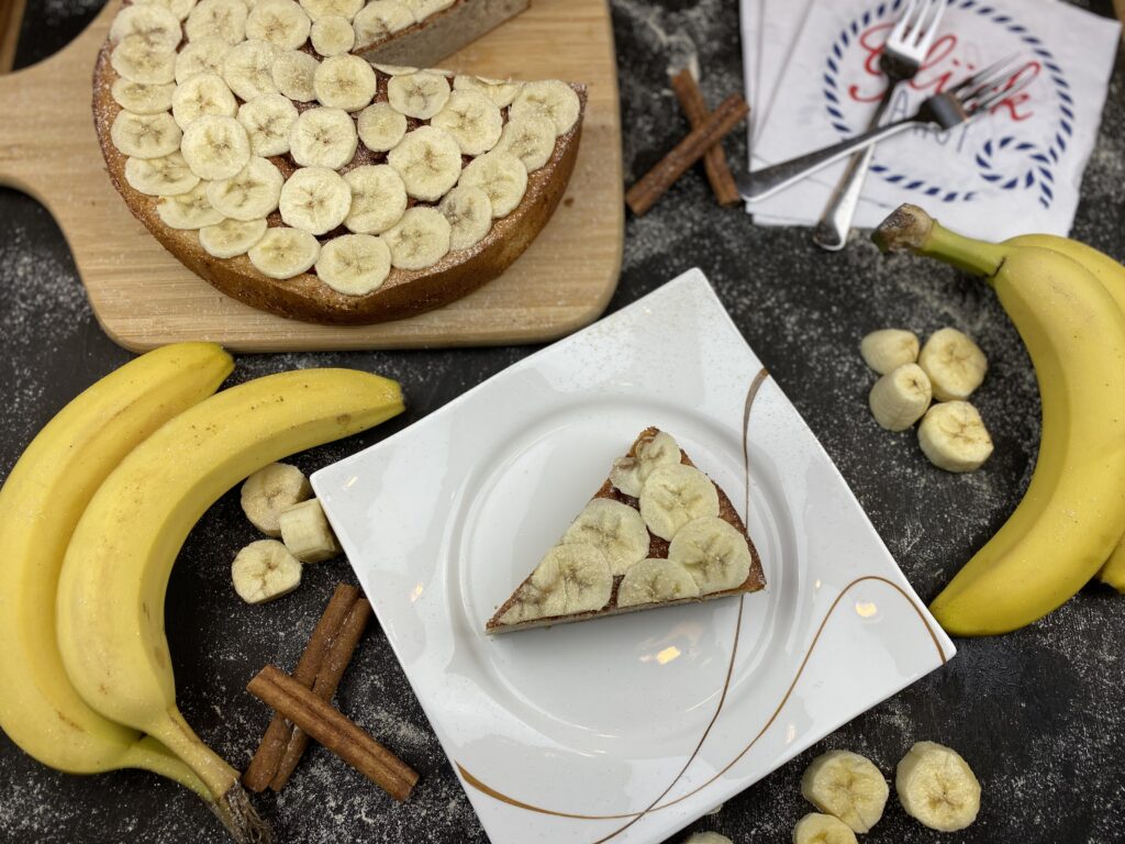 Delicious Banana Cheesecake on Rustic Board with Fresh Bananas Wallpaper