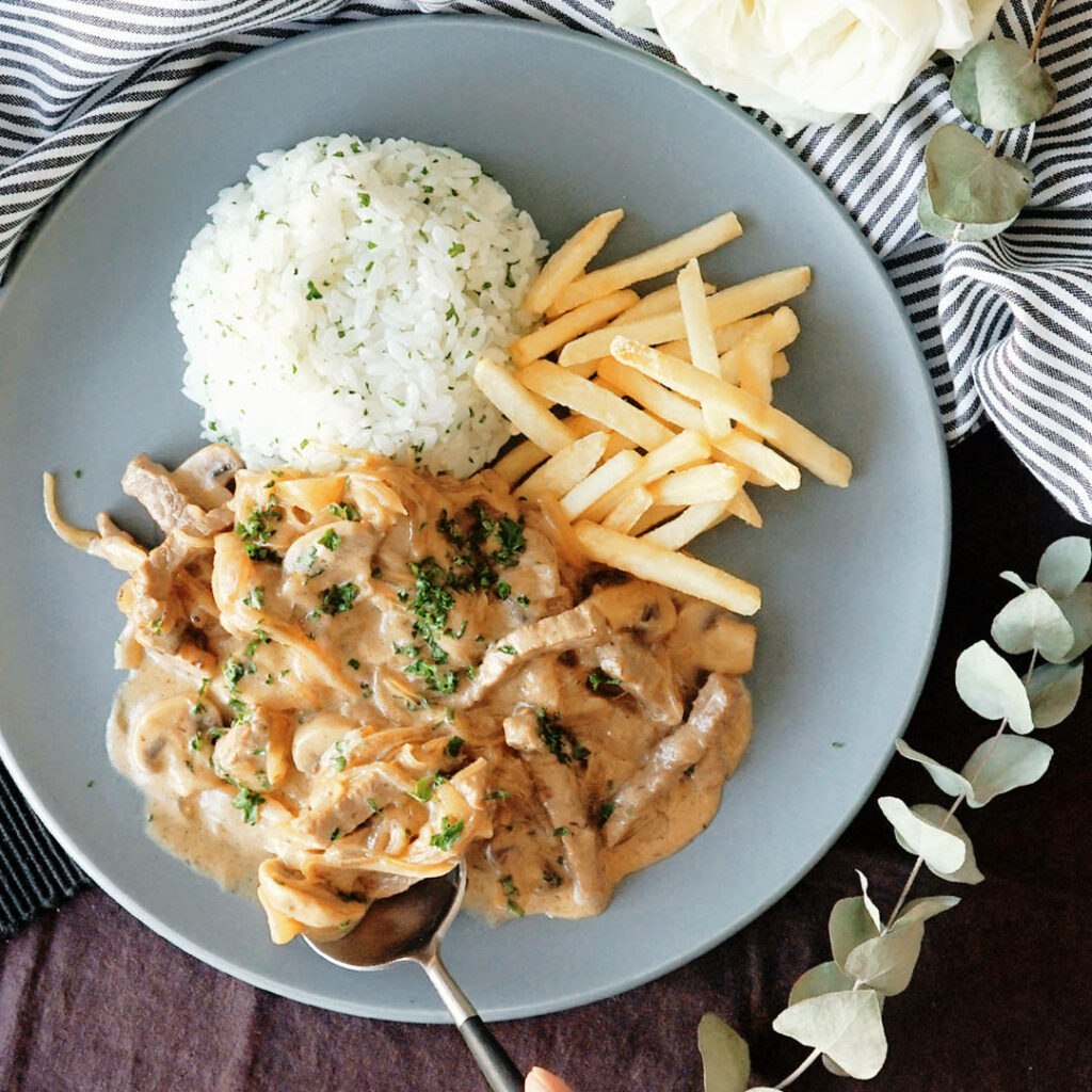 Delicious Beef Stroganoff with Creamy Sauce & Crispy Fries Wallpaper