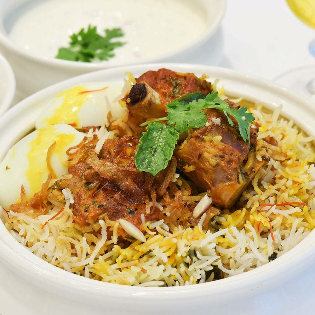 Delicious biryani bowl with tender meat fragrant basmati rice herbs and boiled egg wallpaper