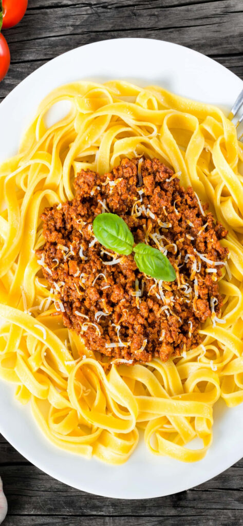Delicious Bolognese Pasta with Basil & Cheese - Rustic Wallpaper