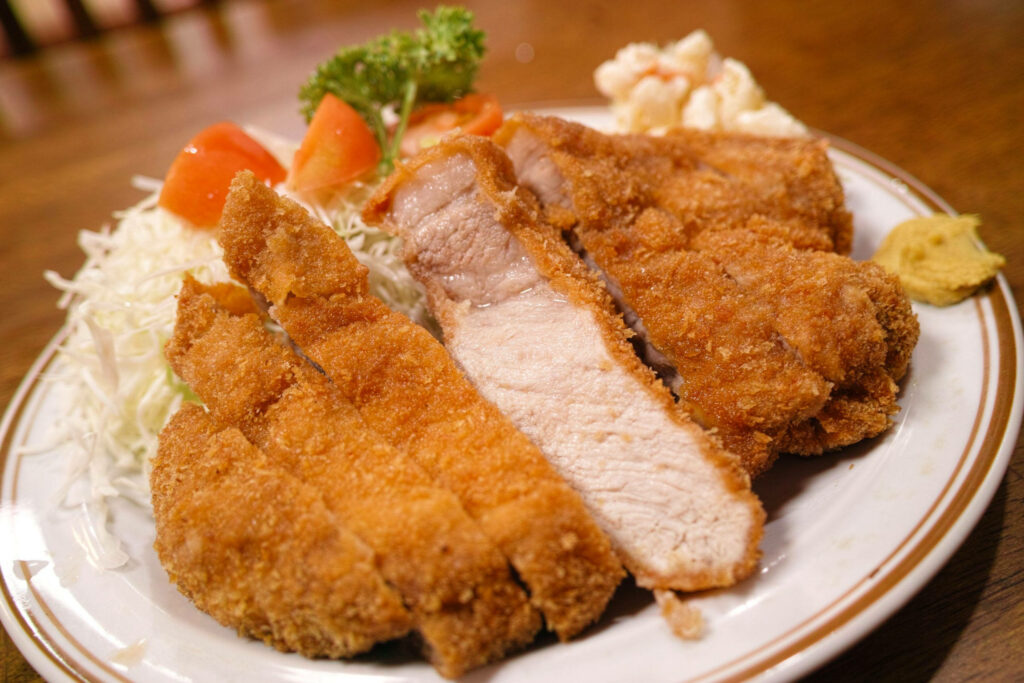 Freshly Cooked Boneless Tonkatsu Wallpaper with Cabbage & Tomatoes