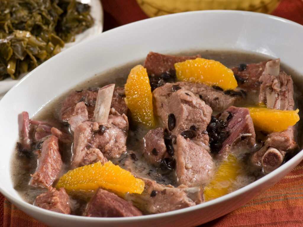 Delicious Brazilian Feijoada Stew with Fresh Orange Slices Wallpaper