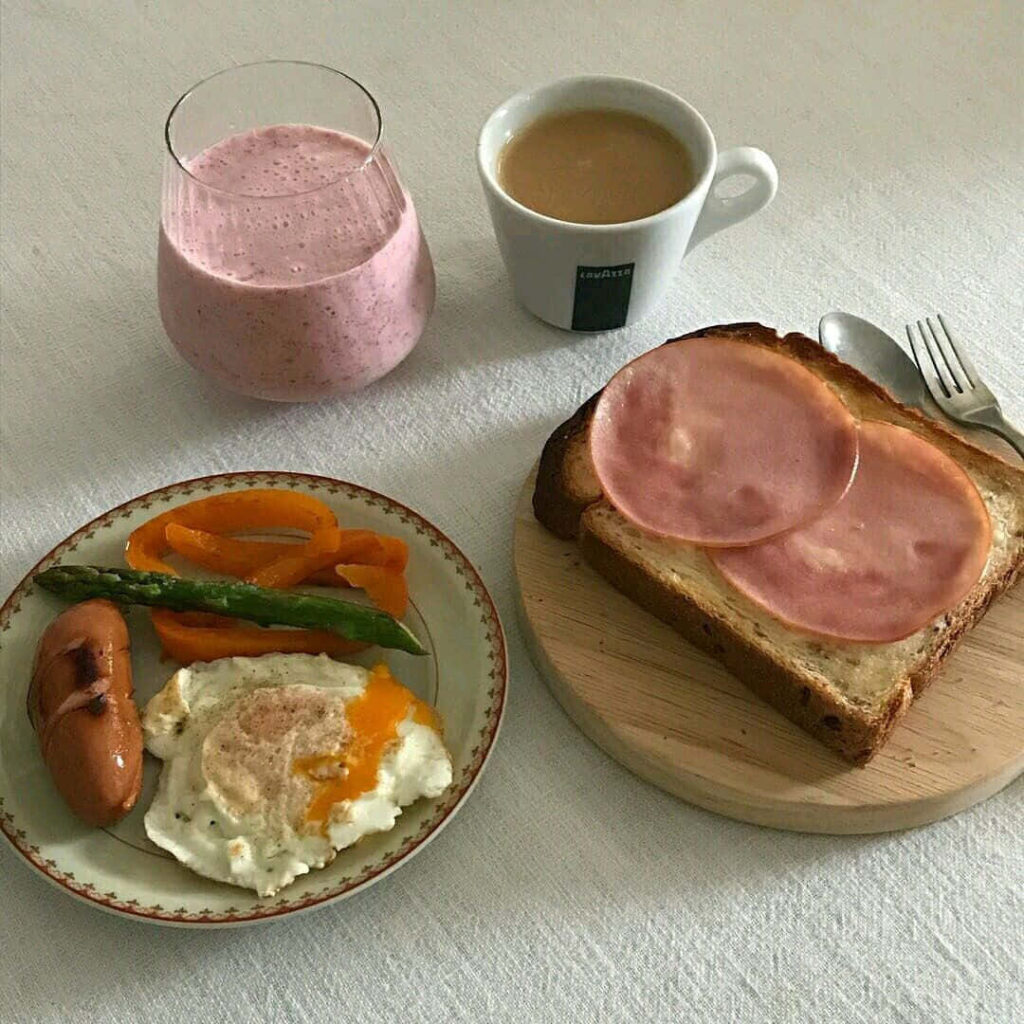 Delicious Breakfast Scene: Toast, Eggs, Sausage & Smoothie Wallpaper
