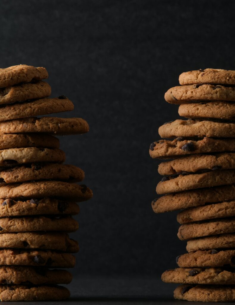 Delicious Brown Cookie Wallpaper with Rich Texture on Dark Background