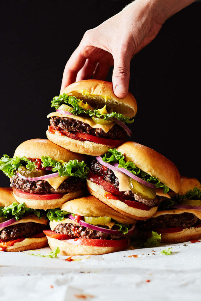 Delectable Burger Stack with Fresh Ingredients - Dark Wallpaper