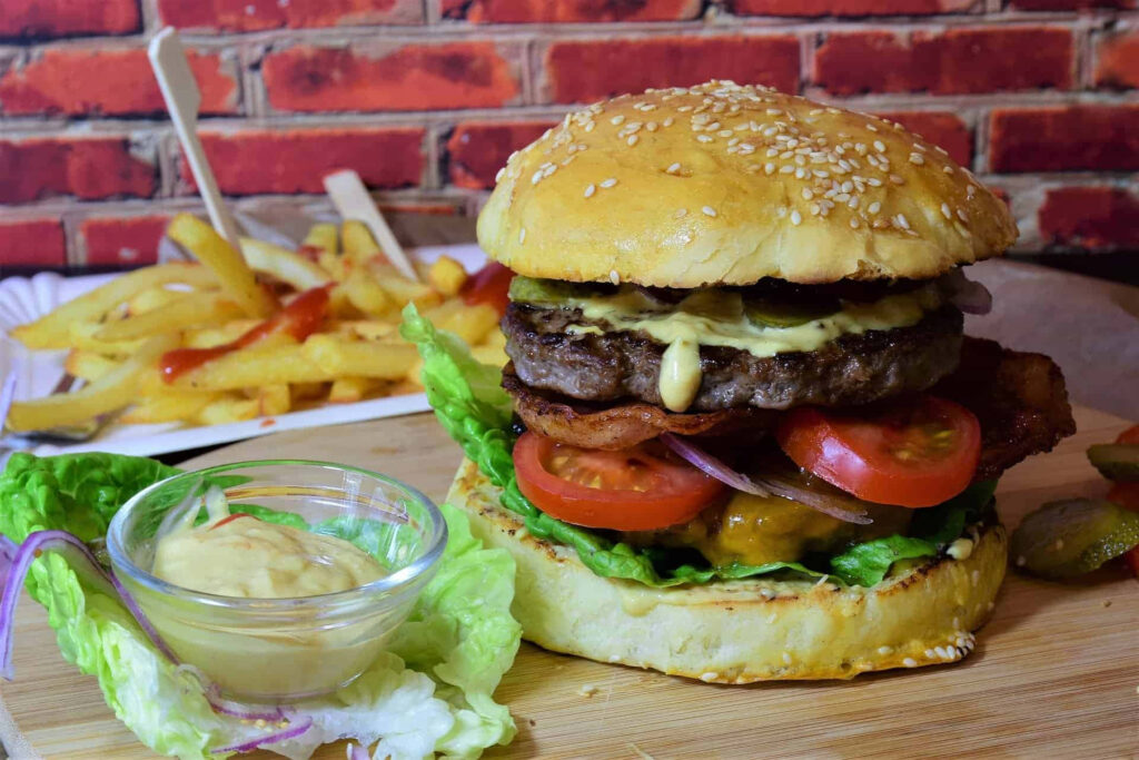 Delicious Burger with Fresh Toppings & Crispy Fries - Rustic Wallpaper