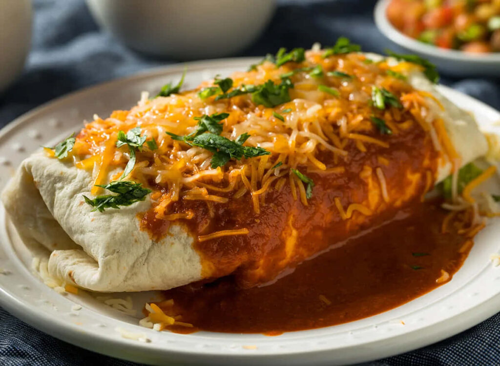 Delicious Burrito Close-Up: Cheese, Sauce & Cilantro Wallpaper