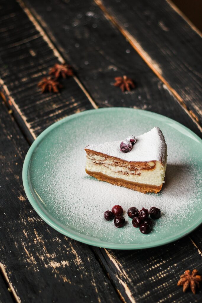 Delicious Cake Slice with Berries on Rustic Wooden Wallpaper