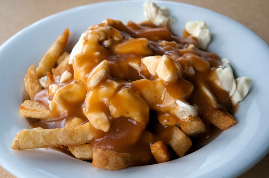 Classic Canadian Poutine Wallpaper: Crispy Fries & Cheese Curds