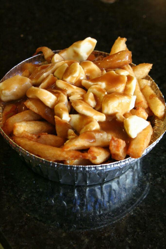 Delicious Canadian Poutine: Crispy Fries & Cheese Curds Wallpaper