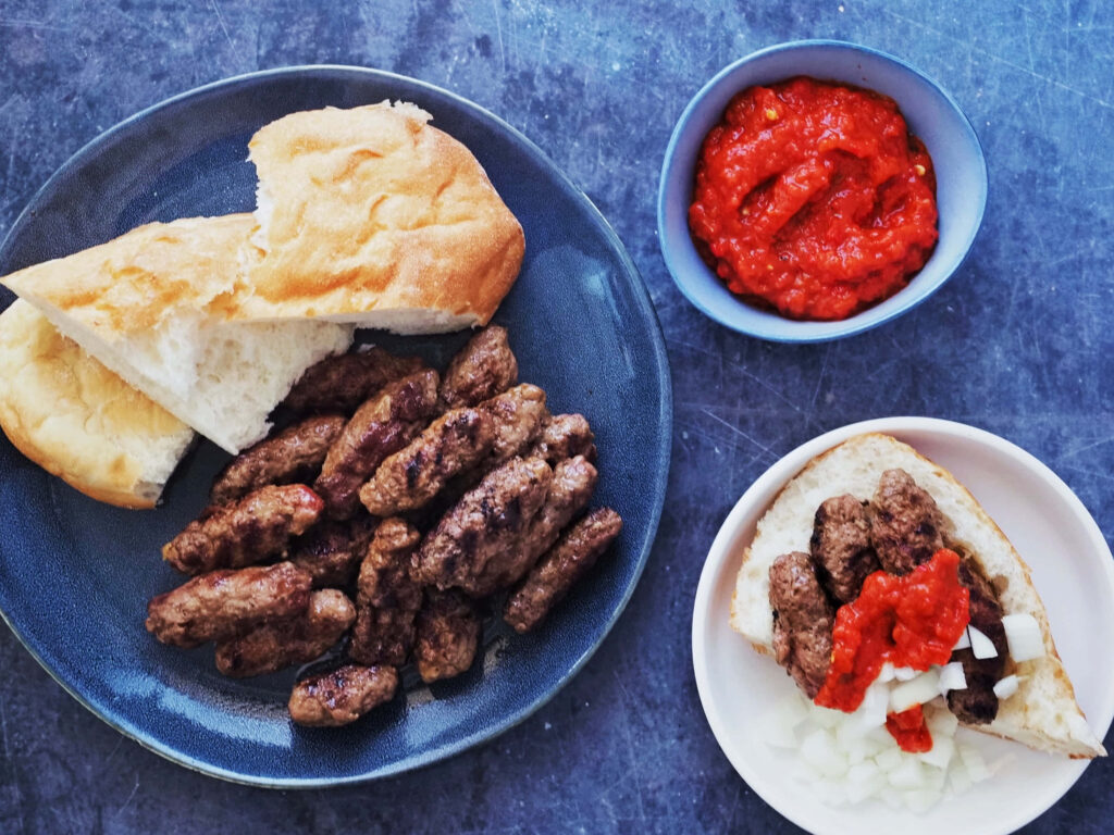 Traditional Cevapi Plate with Pita, Onions & Red Pepper Sauce - Wallpaper