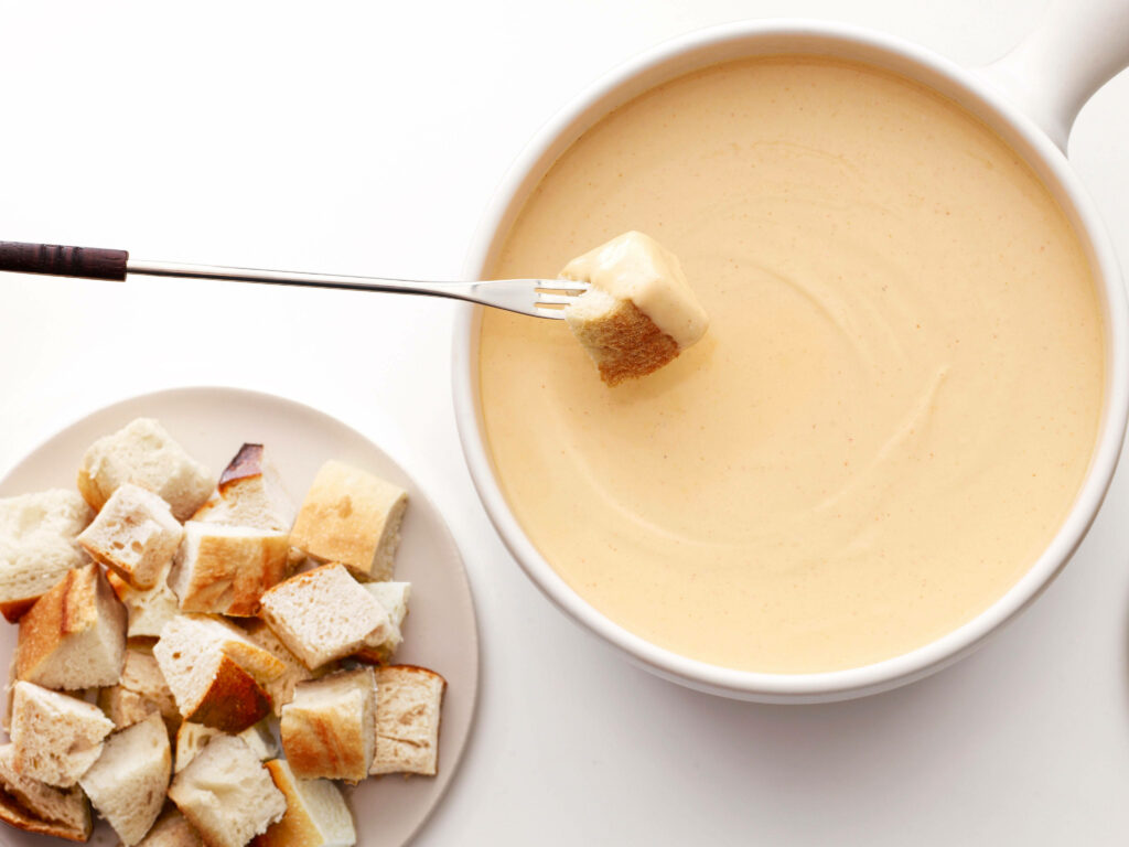 Delicious Cheese Fondue with Bread Cubes - Wallpaper Background