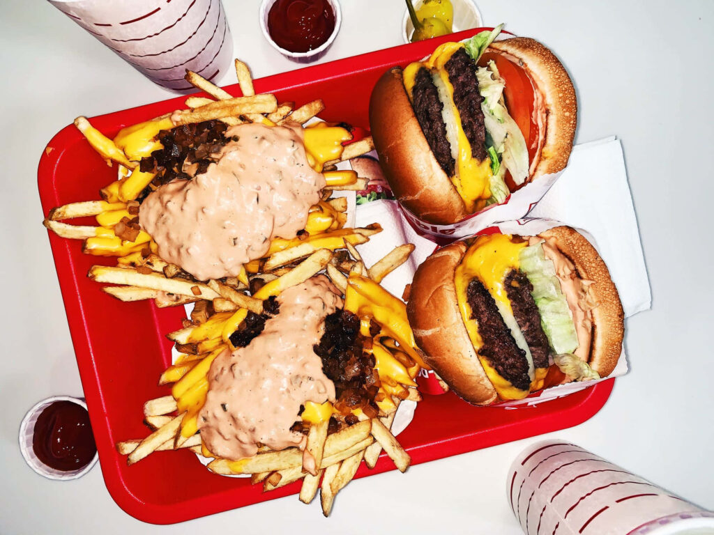 Delicious Cheese Fries & Double Cheeseburgers - Vibrant Red Tray Wallpaper