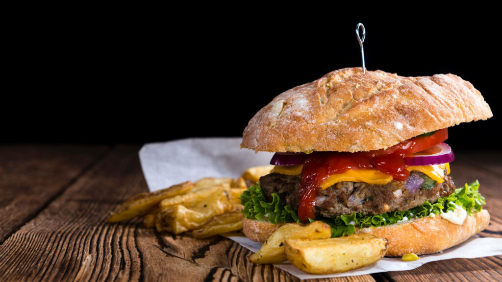 Delicious Cheeseburger with Toppings & Fries - Rustic Wallpaper Background