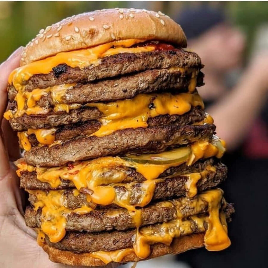 Juicy Cheeseburger Stack: Mouthwatering Wallpaper Background
