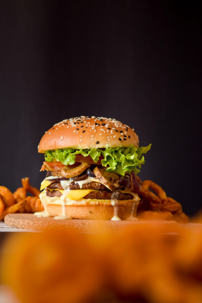 Delicious Cheeseburger Wallpaper with Curly Fries - Mouthwatering Design