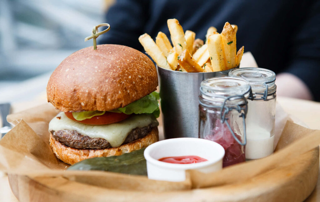 Delicious Burger & Fries on Wooden Tray - Mouthwatering Wallpaper