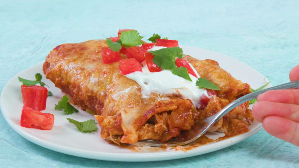 Delicious Enchilada with Cheese & Fresh Toppings on Blue Wallpaper