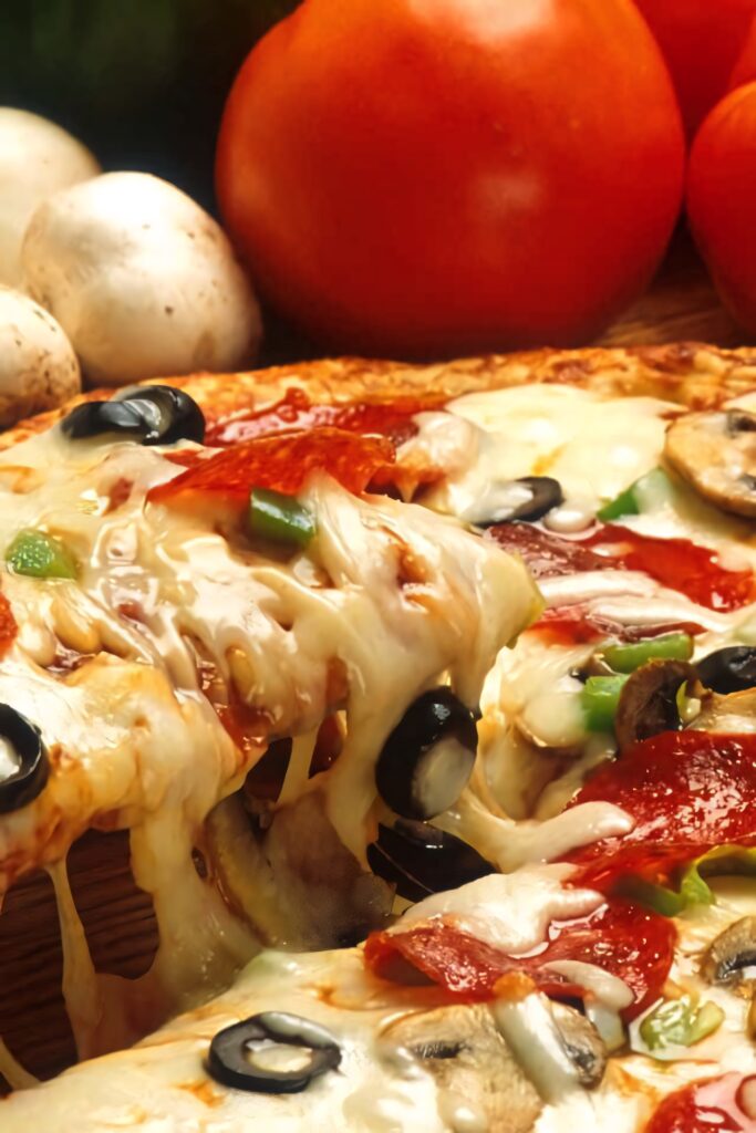 Cheesy Pepperoni Pizza Close-Up with Fresh Ingredients Wallpaper