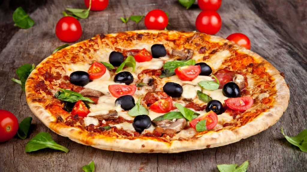 Delicious Cheesy Pizza with Fresh Toppings on Rustic Wood Background Wallpaper