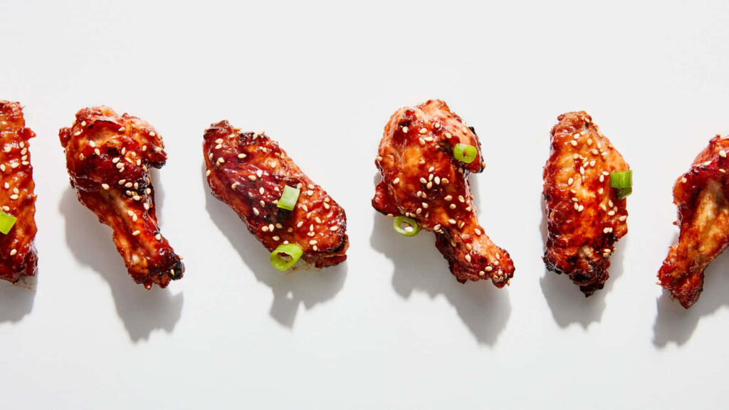 Crispy Chicken Wings Wallpaper: Glazed & Garnished Delight