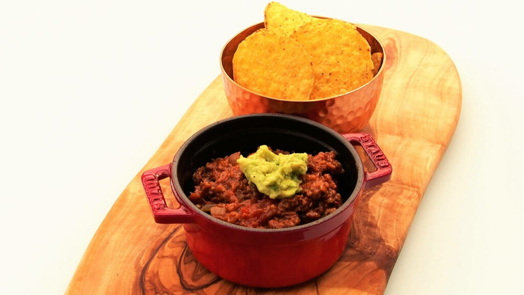 Flavorful Chili Con Carne Wallpaper with Guacamole & Crispy Nachos