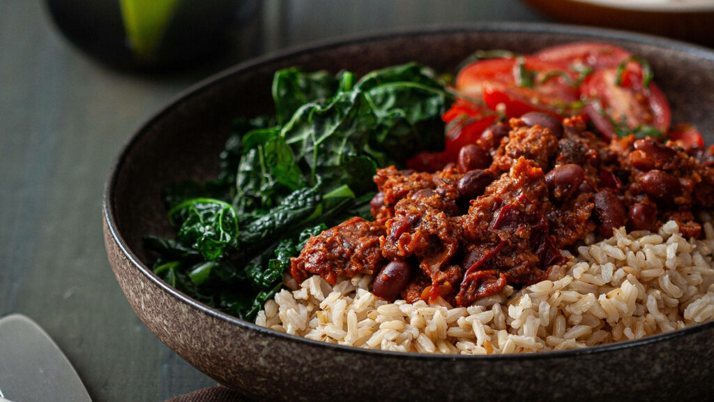 Delicious Chili Con Carne Bowl Wallpaper with Rice & Greens