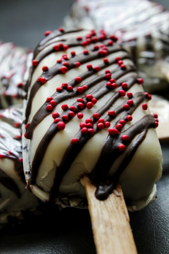 Delicious Chocolate Cake Pop: White Icing & Red Sprinkles Wallpaper