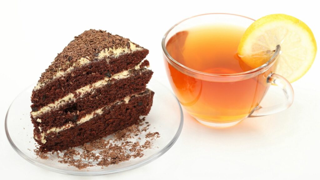 Indulgent Chocolate Cake Slice with Lemon Tea - Wallpaper Background