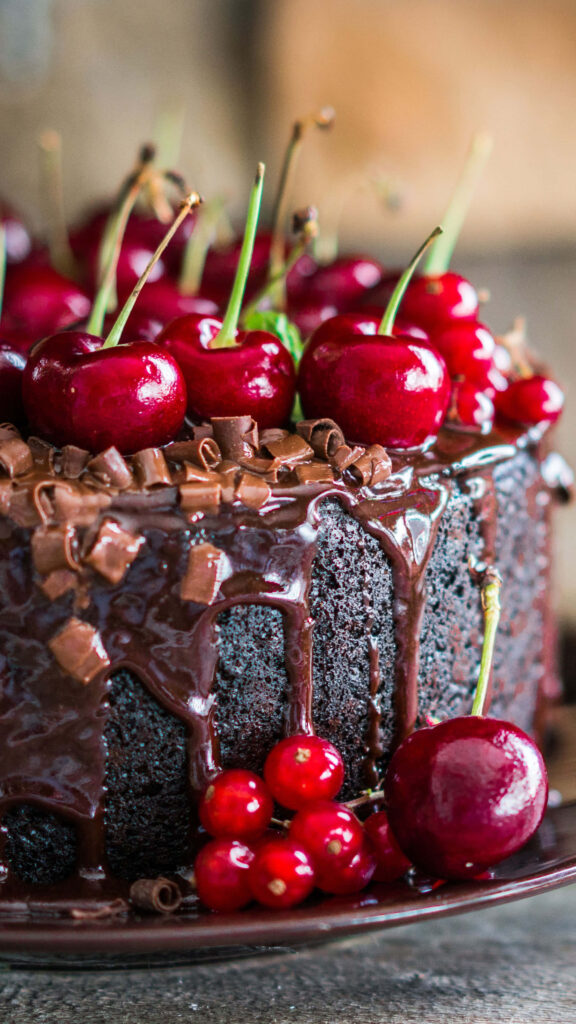 Indulgent Chocolate Cake with Cherries - Delicious Wallpaper Background